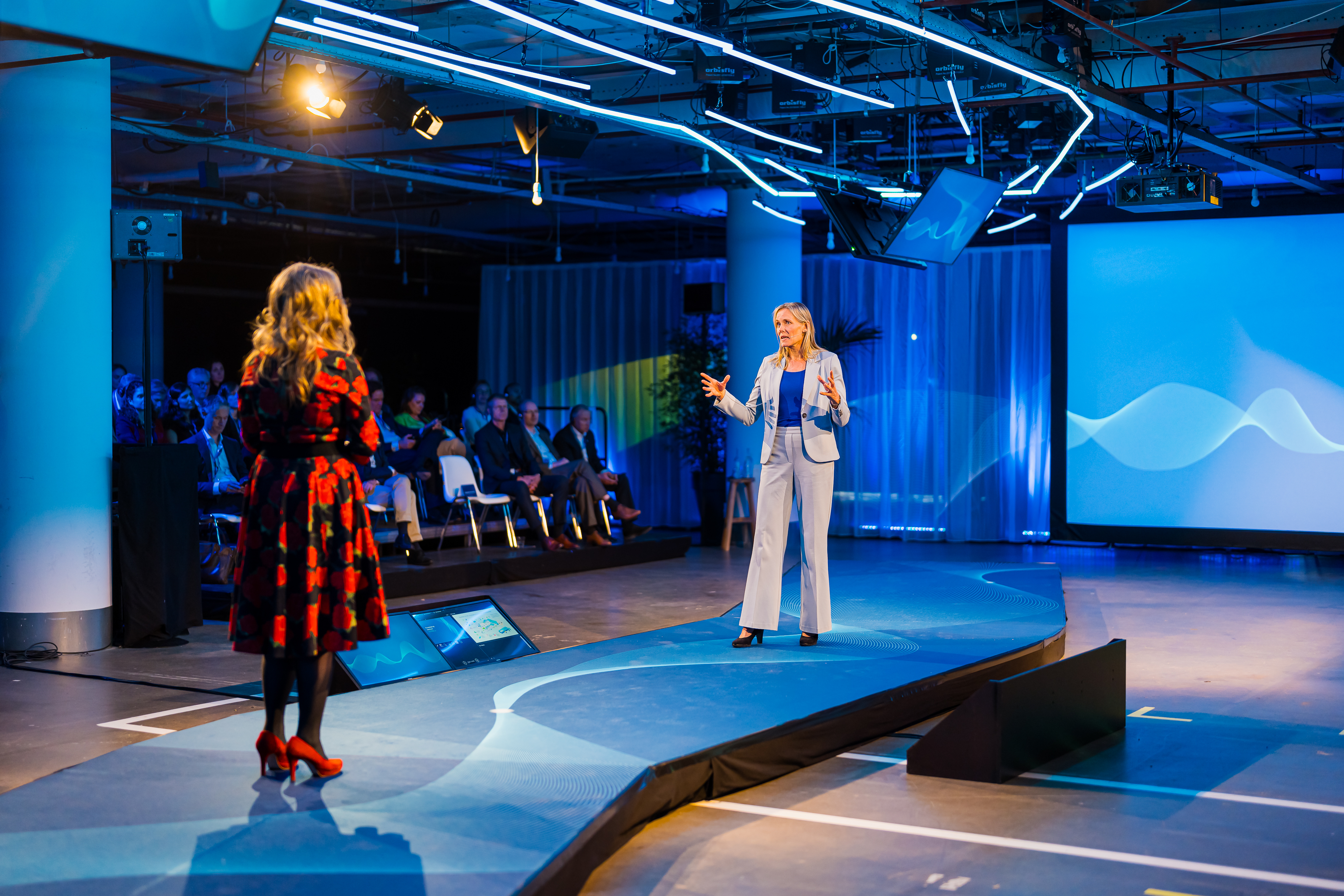 Two woman presenting on stage