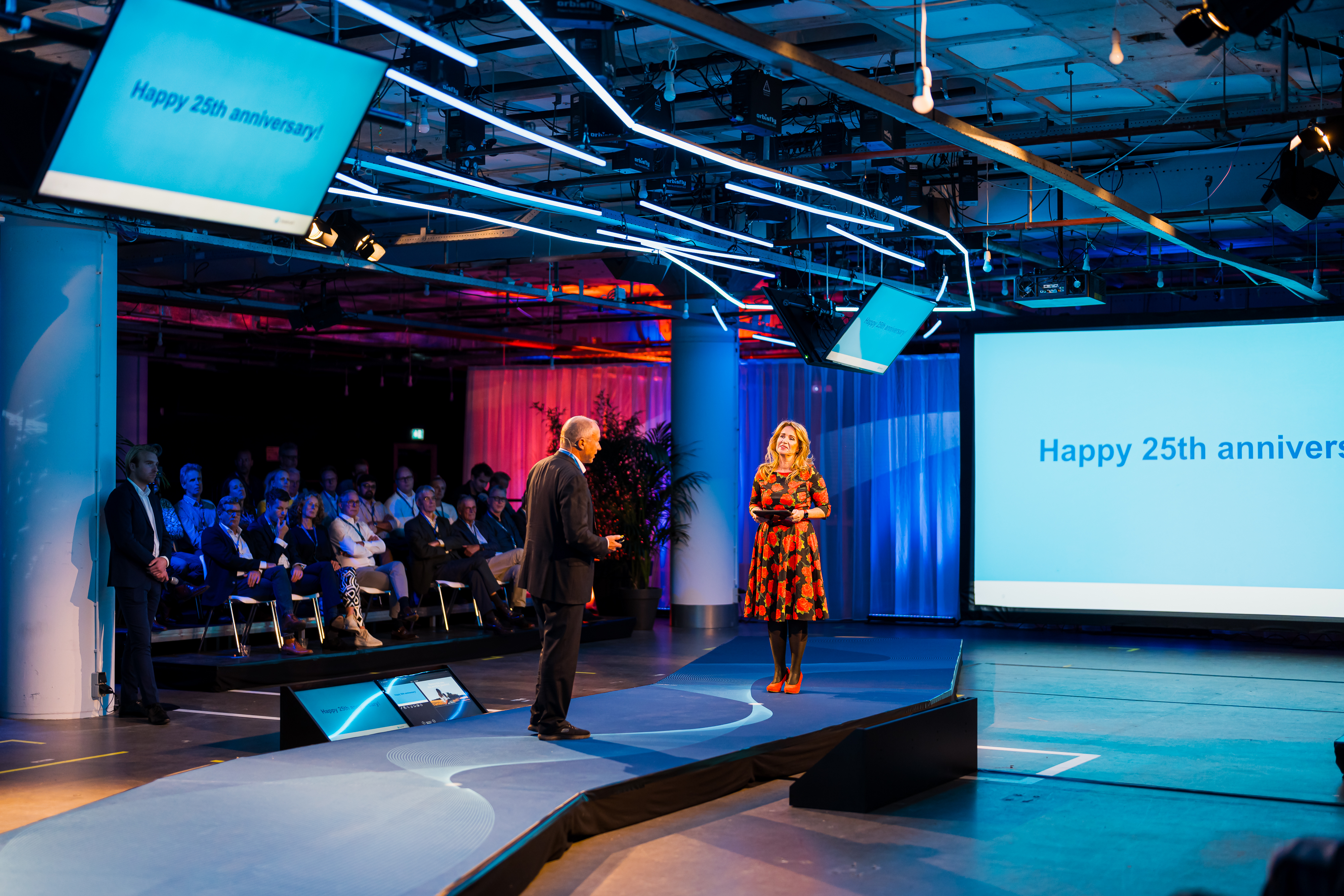 Two people standing on stage